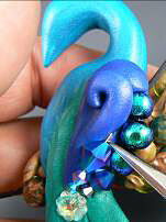 Clay peacock with glass beads